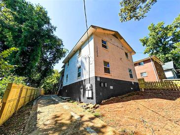 Two-story home featuring a mix of painted brick, black base, and a private driveway at 1152 Greenwich Sw St, Atlanta, GA 30310