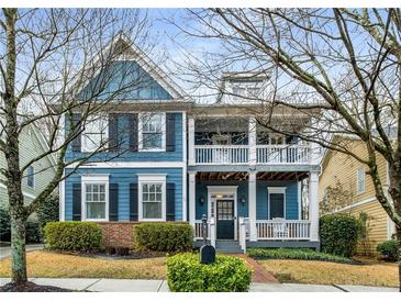 Charming two-story home with blue siding, double porches, and landscaped front yard at 1514 Gilstrap Nw Ln, Atlanta, GA 30318