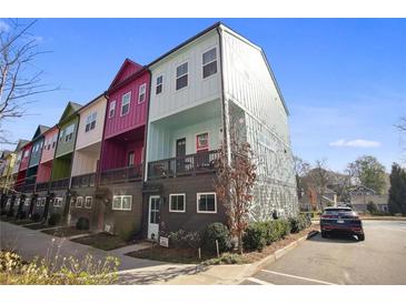 View of colorful townhomes featuring unique architectural details and manicured landscaping at 203 Color Cir, Atlanta, GA 30317