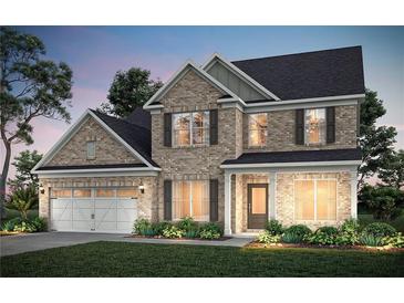 Charming two-story brick home with a well-manicured lawn and a two-car garage at 5310 Julep Ct, Cumming, GA 30028