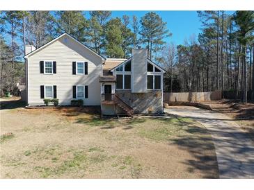 Charming two-story home with a stone facade, complemented by a well-manicured lawn and a long driveway at 55 Bonds Ct, Hiram, GA 30141