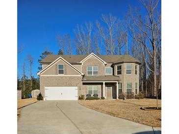 Charming two-story brick home with attached garage and well-maintained lawn at 1001 Brading Pl, Lawrenceville, GA 30043