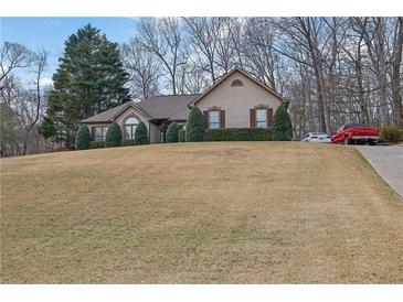 Charming single-story home with a manicured lawn and well-maintained landscaping, offering great curb appeal at 480 Firelite Ln, Suwanee, GA 30024