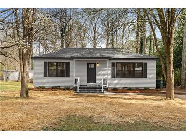 Cozy home with a well-manicured lawn and a welcoming entrance at 1210 Beech St, Marietta, GA 30062