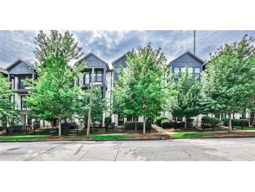 Charming townhomes with black trim and mature trees at 66 Rogers Ne St, Atlanta, GA 30317