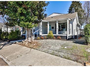 Charming cottage-style home with a covered front porch and landscaping at 32 Howell Se St, Atlanta, GA 30312
