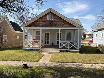 Charming single-story home with a welcoming front porch and well-maintained lawn at 23 Poplar St, Porterdale, GA 30014