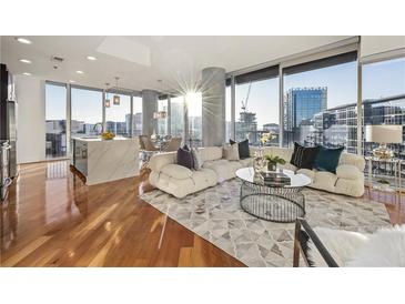 Bright, open living room featuring hardwood floors, floor-to-ceiling windows and city views at 1080 Peachtree Ne St # 2011, Atlanta, GA 30309