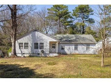 Classic one-story home with a welcoming entrance and a spacious front yard perfect for outdoor activities at 3480 Beech Dr, Decatur, GA 30032