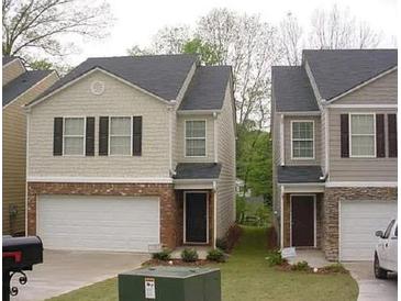 Charming two-story townhome featuring a single-car garage and traditional architectural details at 5175 Hanover St, Atlanta, GA 30349