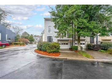 Charming townhome featuring a two-car garage, second story balcony, and professionally landscaped yard at 50 Sycamore Sta, Decatur, GA 30030