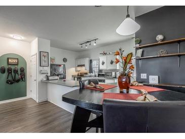 Bright eat-in kitchen features a breakfast bar, white cabinetry and pendant lighting above the dining table at 15 Corinth Rd, Cartersville, GA 30121