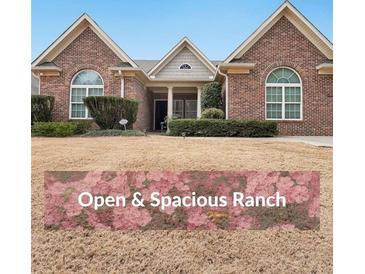 Charming brick ranch home featuring manicured landscaping and arched windows for great curb appeal at 970 Prance Dr, Kennesaw, GA 30144