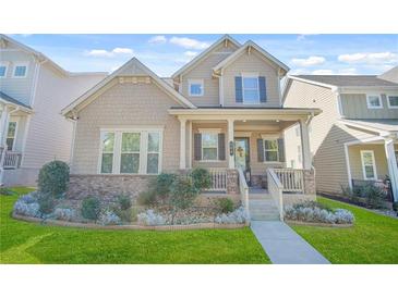 Charming home featuring a covered front porch, manicured lawn and tasteful landscaping enhancing curb appeal at 145 Treeside Ter, Fayetteville, GA 30214