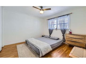 Bright bedroom featuring hardwood floors, a ceiling fan, and soft natural light at 1284 Piedmont Ne Ave # 12, Atlanta, GA 30309