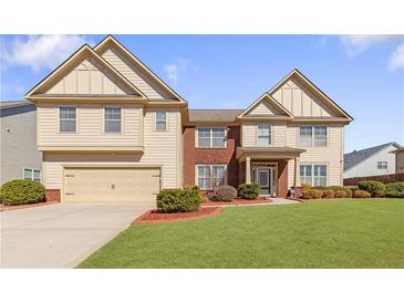 Charming two-story home with a well-manicured lawn and attached two-car garage at 4397 Challedon Dr, South Fulton, GA 30213