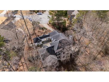 An aerial view of the home's unique architecture, nestled amongst a canopy of trees at 1458 Sweet Bottom Cir, Marietta, GA 30064