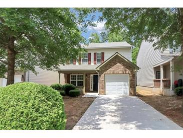Charming two-story home featuring red shutters, a brick accent, and a single-car garage at 4678 Ravenwood Loop, Union City, GA 30291