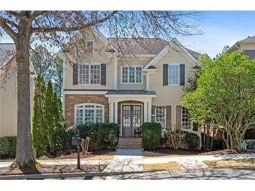 Charming two-story home featuring a stone facade, manicured landscaping, and traditional architectural details at 1967 Mason Mill Rd, Decatur, GA 30033