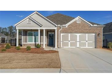 Charming home featuring brick and siding exterior, well-maintained landscaping, and a two-car garage at 171 Echols Bnd, Hiram, GA 30141