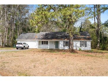 Charming single-story home with white siding, black shutters and a well-manicured front yard at 2931 Oakwilde Ct, Snellville, GA 30039