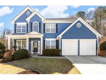 Charming two-story blue home featuring a two-car garage and well-maintained landscaping at 6158 Brookmere Pl, Mableton, GA 30126