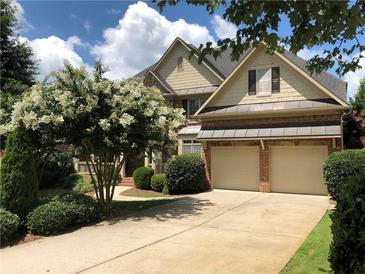 Traditional two-story brick home featuring a two-car garage and beautifully landscaped front yard at 2741 Willowstone Dr, Duluth, GA 30096