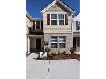 Charming townhome featuring brick and siding exterior, neat landscaping, and a 'For Rent' sign at 2533 Piering Dr, Lithonia, GA 30038
