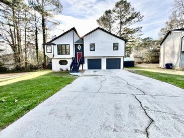 Charming two-story home with a well-maintained lawn and a double garage at 295 Lamden Ct, Lawrenceville, GA 30046