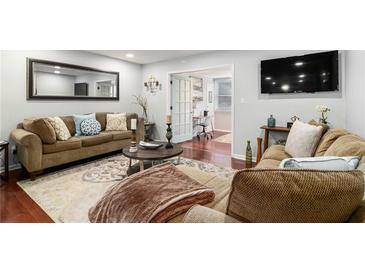 Inviting living room with hardwood floors, comfortable seating, large mirror, and stylish decor at 64 Montre Nw Sq, Atlanta, GA 30327
