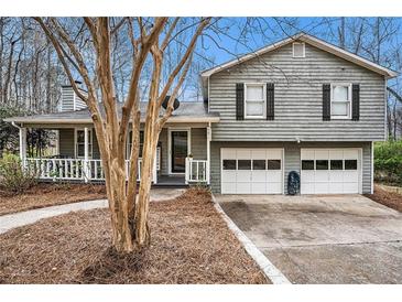 Charming two-story home with gray siding, a covered porch, and a two-car garage at 79 Mountain View Ct, Dallas, GA 30157