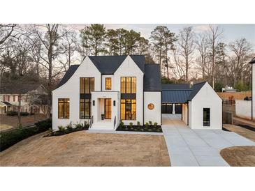 Beautiful new construction with white painted brick and black trim, plus covered three car garage at 906 Fairfield Dr, Marietta, GA 30068