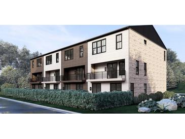 View of a modern townhouse with balconies and a well-manicured landscape at 557 Red Clay Farm Ln, Suwanee, GA 30024