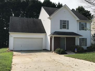 Charming two-story home with white siding, a two-car garage, and a well-maintained front yard at 2143 Gwinn Dr, Norcross, GA 30071