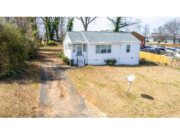 Charming single-story home with a screened porch, a mature yard, and a long driveway at 122 Goldie Se Dr, Marietta, GA 30067