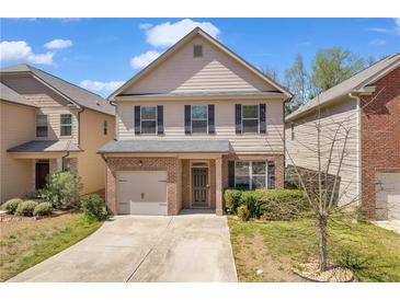 Charming two-story home with a brick facade, gray siding and a well-manicured front lawn at 11961 Lovejoy Crossing Way, Hampton, GA 30228