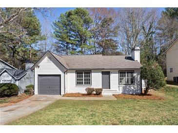 Charming single-story home featuring a well-manicured front lawn and attached garage at 2070 Charles Cudd Ct, Lithonia, GA 30058