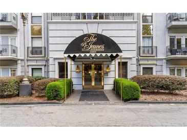 Welcoming condo building entrance at the St James at Buckhead with a black awning and decorative golden door at 3203 Lenox Ne Rd # 1, Atlanta, GA 30324