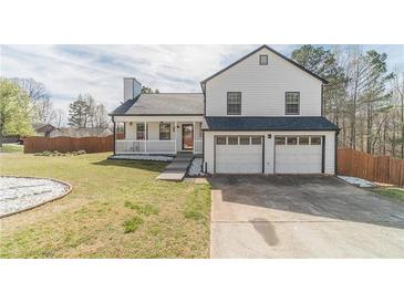 Charming two-story home with a manicured lawn, covered porch, and two-car garage at 785 Josh Ln, Lawrenceville, GA 30045