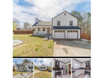 Charming home with a two-car garage, front porch, and manicured lawn at 785 Josh Ln, Lawrenceville, GA 30045