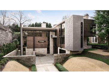 Stunning modern home featuring stone, wood, and metal accents with beautiful landscaping at 79 Beverly Ne Rd, Atlanta, GA 30309