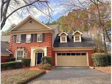 Charming brick home featuring a two-car garage and well-manicured landscaping at 7155 Roswell Rd # 37, Sandy Springs, GA 30328