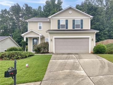 Charming two-story home with a well-maintained lawn, two-car garage and inviting curb appeal at 265 Edinburgh Ln, Woodstock, GA 30188