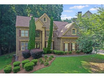 Stunning two-story brick home with lush landscaping and a well-manicured lawn creates lovely curb appeal at 403 Glenhurst Trce, Canton, GA 30115