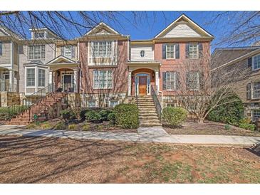 Charming brick townhome with manicured landscaping and inviting entryway stairs at 775 Mountain View Nw Ter, Marietta, GA 30064