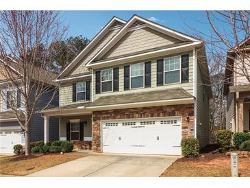 Charming two-story home with stone accents, a two-car garage, and neutral-colored siding at 903 Hollytree Pl, Acworth, GA 30102