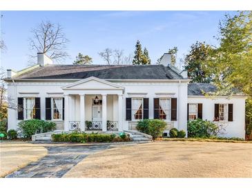Charming white home featuring a classic facade with black shutters and a well-maintained front lawn at 2 W Muscogee Nw Ave, Atlanta, GA 30305