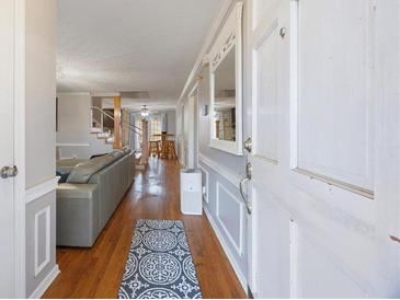 Inviting entryway featuring hardwood floors, neutral walls, and a view into the home's open-concept living space at 135 Cowan Trl, Stockbridge, GA 30281