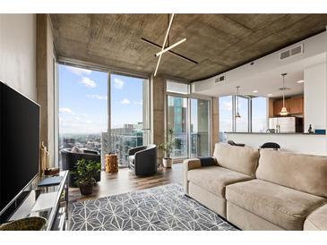 Bright living room with floor-to-ceiling windows and open concept layout into the modern kitchen at 855 Peachtree St # 2901, Atlanta, GA 30308