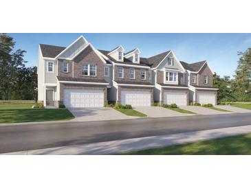 Charming townhomes with brick accents, attached garages and professionally landscaped yards at 2443 Livi Ln, Buford, GA 30519